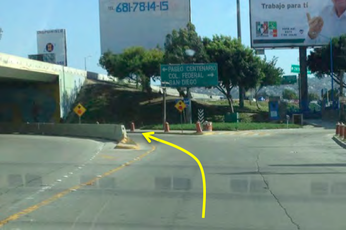 12. Stay in the middle lane and follow the signs for PASEO CENTENARIO which will lead you to the left (but stay to the RIGHT of the concrete barrier). You will go under the bridge. 